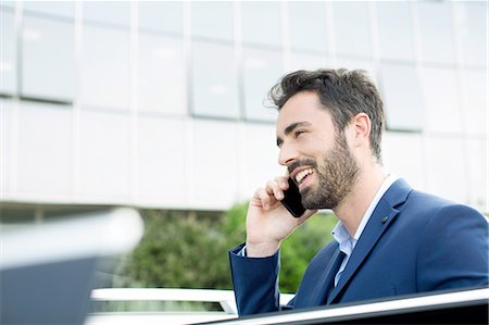 simsearch:614-08877313,k - Young businessman talking on smartphone outside office Stock Photo - Premium Royalty-Free, Code: 649-08306368