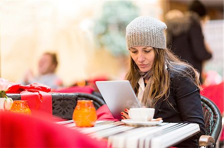 simsearch:649-07560110,k - Mature woman browsing digital tablet at sidewalk cafe Stock Photo - Premium Royalty-Free, Code: 649-08306538