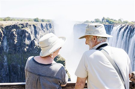 Couple looking out to Victoria Falls, Zambia Stock Photo - Premium Royalty-Free, Code: 649-08306569