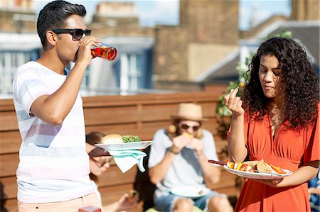 simsearch:649-07648576,k - Friends eating party food and drinking at rooftop party Stock Photo - Premium Royalty-Free, Code: 649-08306626