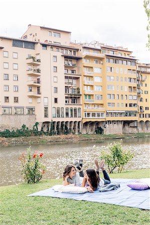 simsearch:649-08306727,k - Lesbian couple lying on front on blanket next to Arno river, Florence, Tuscany, Italy Stock Photo - Premium Royalty-Free, Code: 649-08306715