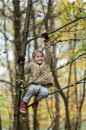 simsearch:649-08306781,k - Girl hanging on to tree branch in autumn forest Stock Photo - Premium Royalty-Free, Code: 649-08306774