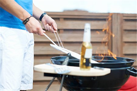 roof terrace - Cropped shot of mid adult man barbecuing at rooftop barbecue Stock Photo - Premium Royalty-Free, Code: 649-08306808