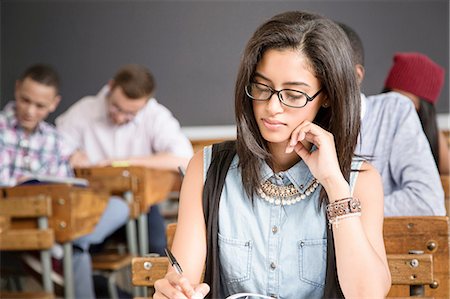 simsearch:841-08568945,k - Female student, sitting at desk in classroom, writing Stock Photo - Premium Royalty-Free, Code: 649-08306872