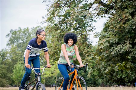 Mother and son riding on bicycles smiling Stock Photo - Premium Royalty-Free, Code: 649-08307022