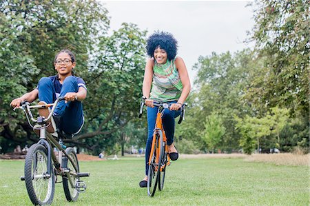 Front view of mother and son riding on bicycles smiling Stock Photo - Premium Royalty-Free, Code: 649-08307023