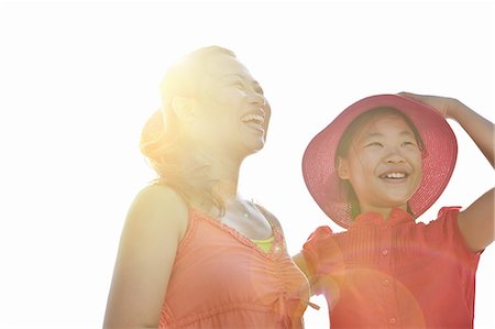 Happy mid adult woman and daughter in sunlight Fotografie stock - Premium Royalty-Free, Codice: 649-08307161