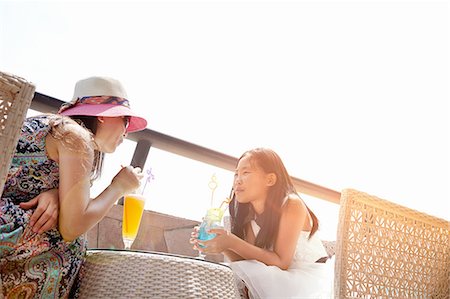 drinking soda in summer - Girl and mother with soft drinks at beach cafe, Zhuhai, Guangdong, China Stock Photo - Premium Royalty-Free, Code: 649-08307185