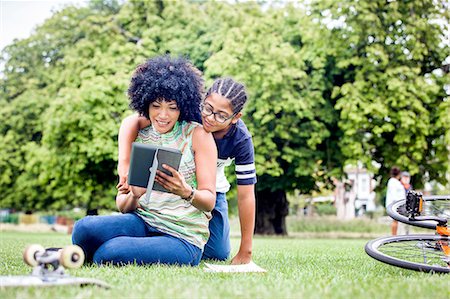 Boy and mother reading digital tablet together in park Stock Photo - Premium Royalty-Free, Code: 649-08307199
