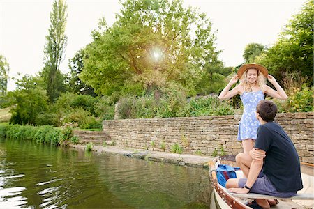 simsearch:649-08307314,k - Young woman with boyfriend standing in rowing boat on river Foto de stock - Sin royalties Premium, Código: 649-08307324