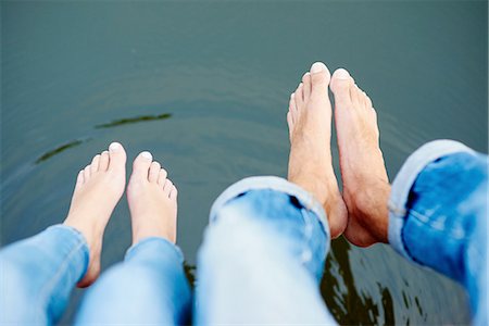 dangling teenage - Overhead view of bare feet and legs of young couple on river footbridge Stock Photo - Premium Royalty-Free, Code: 649-08307347