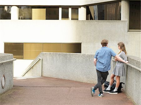 simsearch:649-07737040,k - Young couple chatting on walkway, Melbourne, Victoria, Australia Photographie de stock - Premium Libres de Droits, Code: 649-08307370