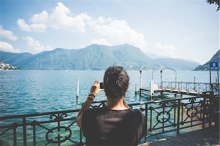 simsearch:649-08144840,k - Rear view of mid adult woman photographing with smartphone, Lake Lugano, Switzerland Stock Photo - Premium Royalty-Free, Code: 649-08307476