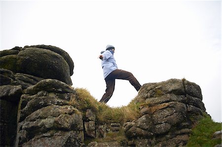 simsearch:649-08560872,k - Low angle view of woman on rock formation, Dartmoor, Devon, UK Fotografie stock - Premium Royalty-Free, Codice: 649-08327622