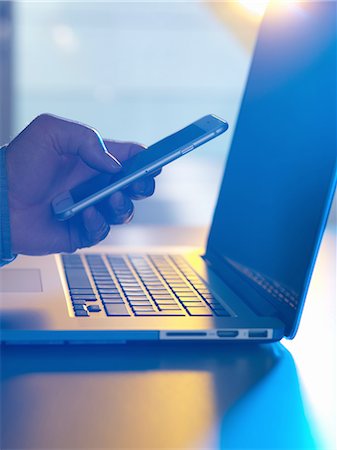 Man texting at laptop computer Stock Photo - Premium Royalty-Free, Code: 649-08327666