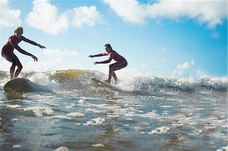 Two surfers riding wave Stock Photo - Premium Royalty-Free, Code: 649-08327899