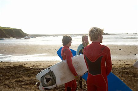 simsearch:649-08307235,k - Group of surfers standing on beach, holding surfboards, rear view Stockbilder - Premium RF Lizenzfrei, Bildnummer: 649-08327904
