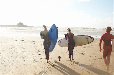 simsearch:649-02054536,k - Group of surfers heading towards sea, carrying surfboards, rear view Stock Photo - Premium Royalty-Free, Code: 649-08327903