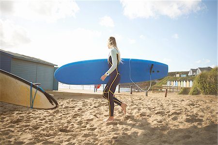 simsearch:649-02054536,k - Female surfer on beach, carrying surfboard Stock Photo - Premium Royalty-Free, Code: 649-08327916