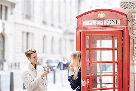 pictures of england people talking - Young couple with smartphone next to red phone box, London, England, UK Stock Photo - Premium Royalty-Free, Code: 649-08328059