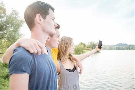 simsearch:649-09111243,k - Three young adults taking self portrait, using smartphone, outdoors Photographie de stock - Premium Libres de Droits, Code: 649-08328244