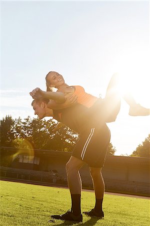 Young woman training back to back with personal trainer Stock Photo - Premium Royalty-Free, Code: 649-08328363