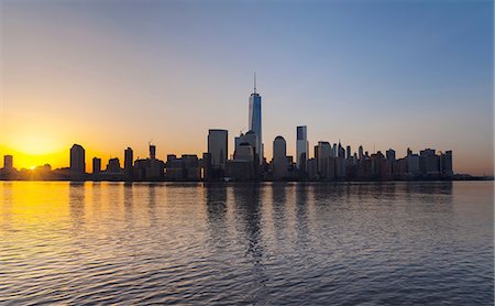 simsearch:649-08328534,k - Silhouetted view of Manhattan financial district skyline at sunset, New York, USA Stock Photo - Premium Royalty-Free, Code: 649-08328534