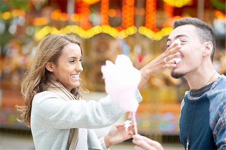 simsearch:649-09025836,k - Young couple, fooling around, eating candy floss at funfair, outdoors Foto de stock - Sin royalties Premium, Código: 649-08328771