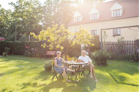 Senior couple, sitting at table in garden, enjoying drink Stock Photo - Premium Royalty-Free, Code: 649-08380920