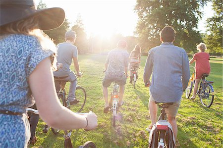 simsearch:649-08949872,k - Rear view of party going adults arriving in park on bicycles at sunset Stock Photo - Premium Royalty-Free, Code: 649-08381075