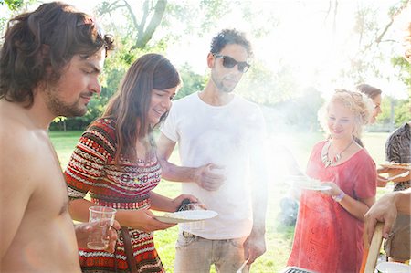 Adult friends waiting for BBQ at sunset park party Stock Photo - Premium Royalty-Free, Code: 649-08381157