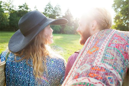 simsearch:649-01608481,k - Rear view of romantic young couple carrying rug for picnic in park Stock Photo - Premium Royalty-Free, Code: 649-08381153