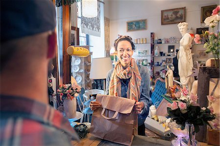 selling business - Happy young female customer buying from vintage shop Stock Photo - Premium Royalty-Free, Code: 649-08381303