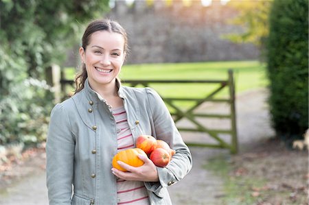 fresh outdoors - Portrait of woman holding apples and pumpkin at Thornbury Castle, South Gloucestershire, UK Stock Photo - Premium Royalty-Free, Code: 649-08381745