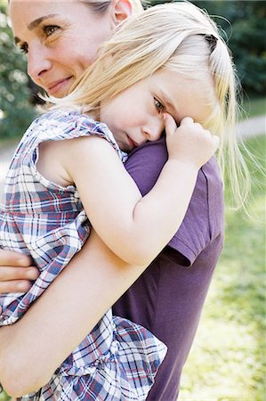 sad daughter to mom - Mid adult woman carrying upset daughter in park Stock Photo - Premium Royalty-Free, Code: 649-08422520