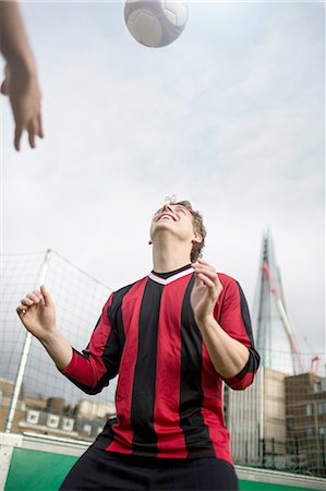simsearch:649-08422762,k - Young man practising football skills on urban football pitch Stockbilder - Premium RF Lizenzfrei, Bildnummer: 649-08422744