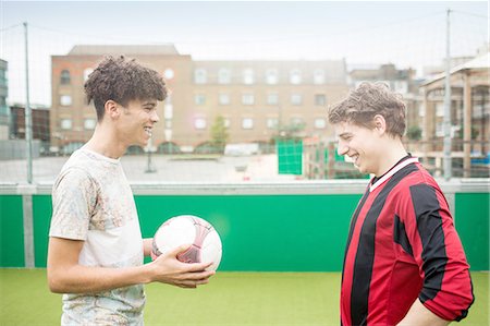 simsearch:649-08422762,k - Two young men playing football on urban football pitch Stockbilder - Premium RF Lizenzfrei, Bildnummer: 649-08422742