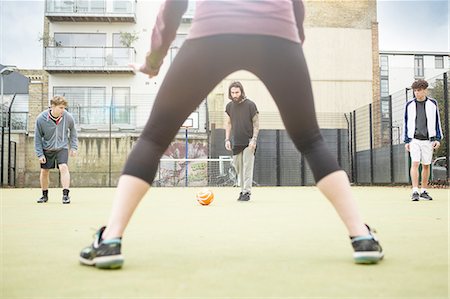 simsearch:6122-07697777,k - Group of adults playing football on urban football pitch Photographie de stock - Premium Libres de Droits, Code: 649-08422755