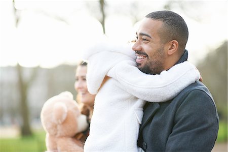 simsearch:632-01147960,k - Side view of smiling father carrying daughter Stock Photo - Premium Royalty-Free, Code: 649-08423369