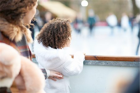family skating - Rear view of mother and daughter watching people ice skating on ice rink Stock Photo - Premium Royalty-Free, Code: 649-08423372