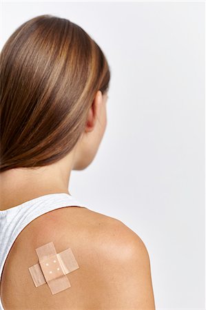 Woman with plaster on back of right shoulder Stock Photo - Premium Royalty-Free, Code: 649-08479310