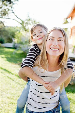 piggy back - Mother giving daughter piggy back Stock Photo - Premium Royalty-Free, Code: 649-08479458