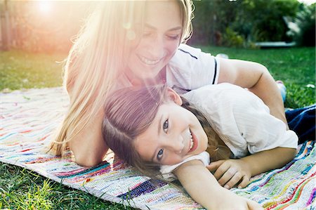 Mother and daughter lying on rug in garden Stock Photo - Premium Royalty-Free, Code: 649-08479530