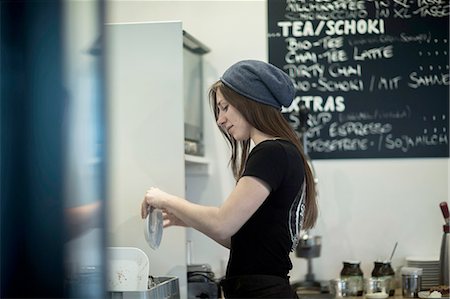 Young female waitress working in cafe kitchen Stock Photo - Premium Royalty-Free, Code: 649-08479800