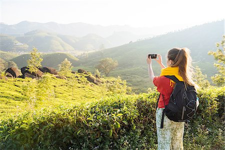 Young woman photographing tea plantations near Munnar, Kerala, India Stock Photo - Premium Royalty-Free, Code: 649-08480036