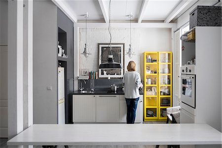 Rear view of woman preparing food at kitchen hob Photographie de stock - Premium Libres de Droits, Code: 649-08480042
