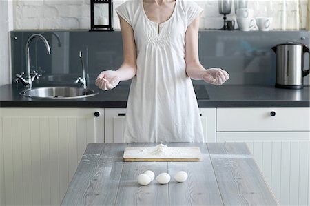 encimera de cocina - Cropped shot of woman baking with eggs and flour at kitchen table Foto de stock - Sin royalties Premium, Código: 649-08480050