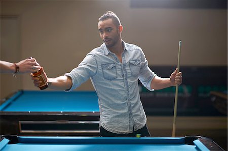 simsearch:649-07238907,k - Man taking beer from friend at pool table Stock Photo - Premium Royalty-Free, Code: 649-08480203
