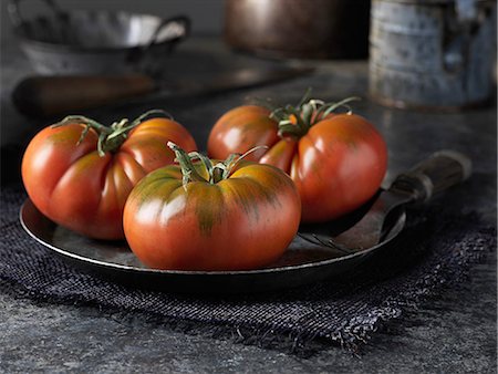 Red beef tomatoes on vintage metal plate Stock Photo - Premium Royalty-Free, Code: 649-08480316