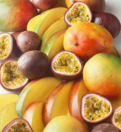Stack of tropical fruit with mangoes and passion fruit, sliced and whole Stock Photo - Premium Royalty-Free, Code: 649-08480313